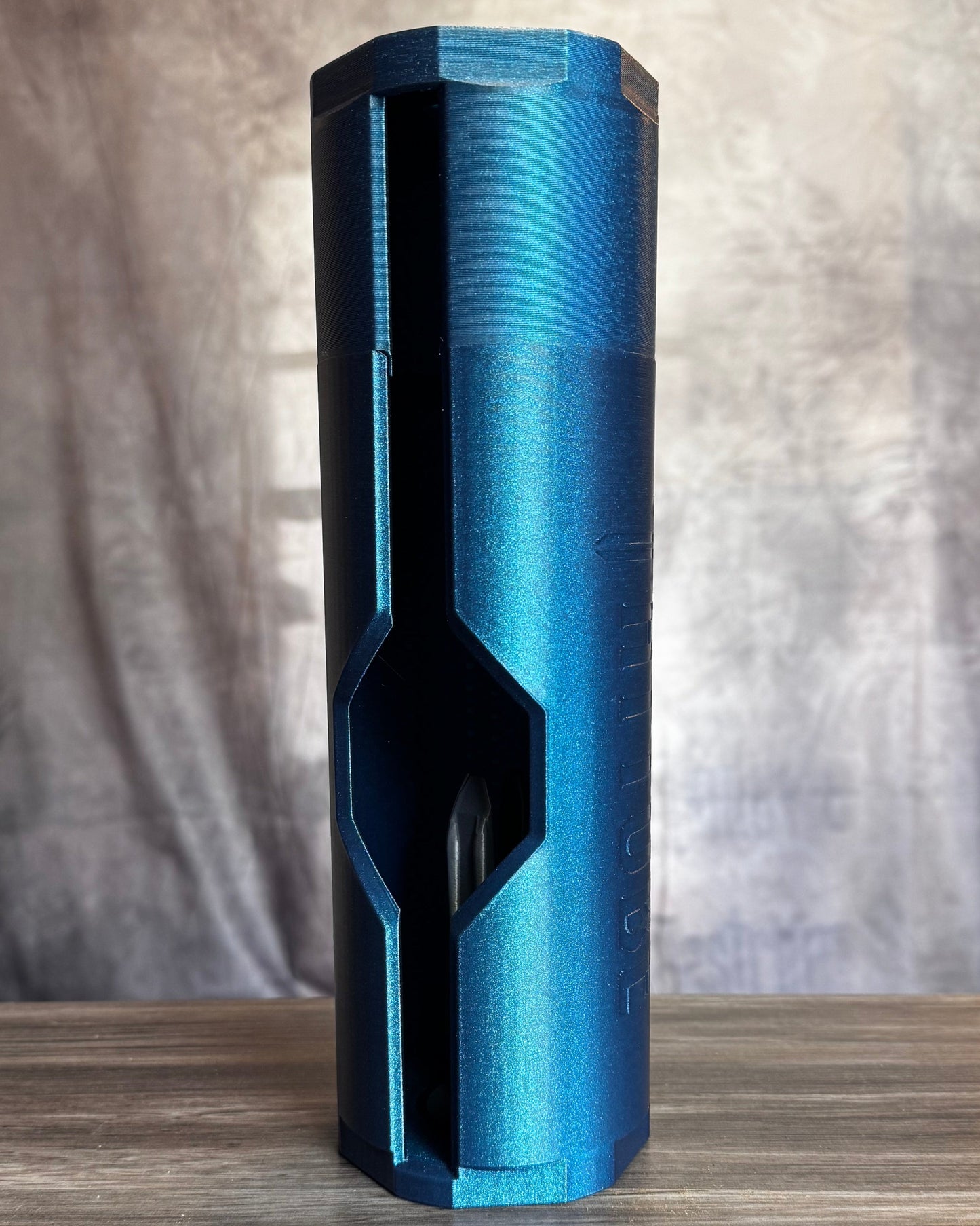 Blue cylindrical object on a wooden surface